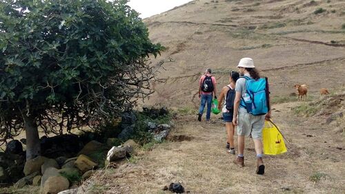 picking up plastic garbage while hiking down to Maia in Santa Maria East coast